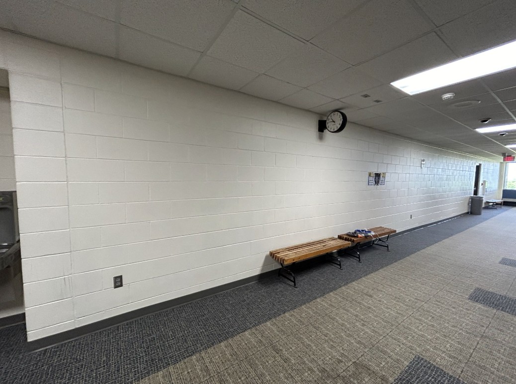 Blank white brick hallway wall before graphics