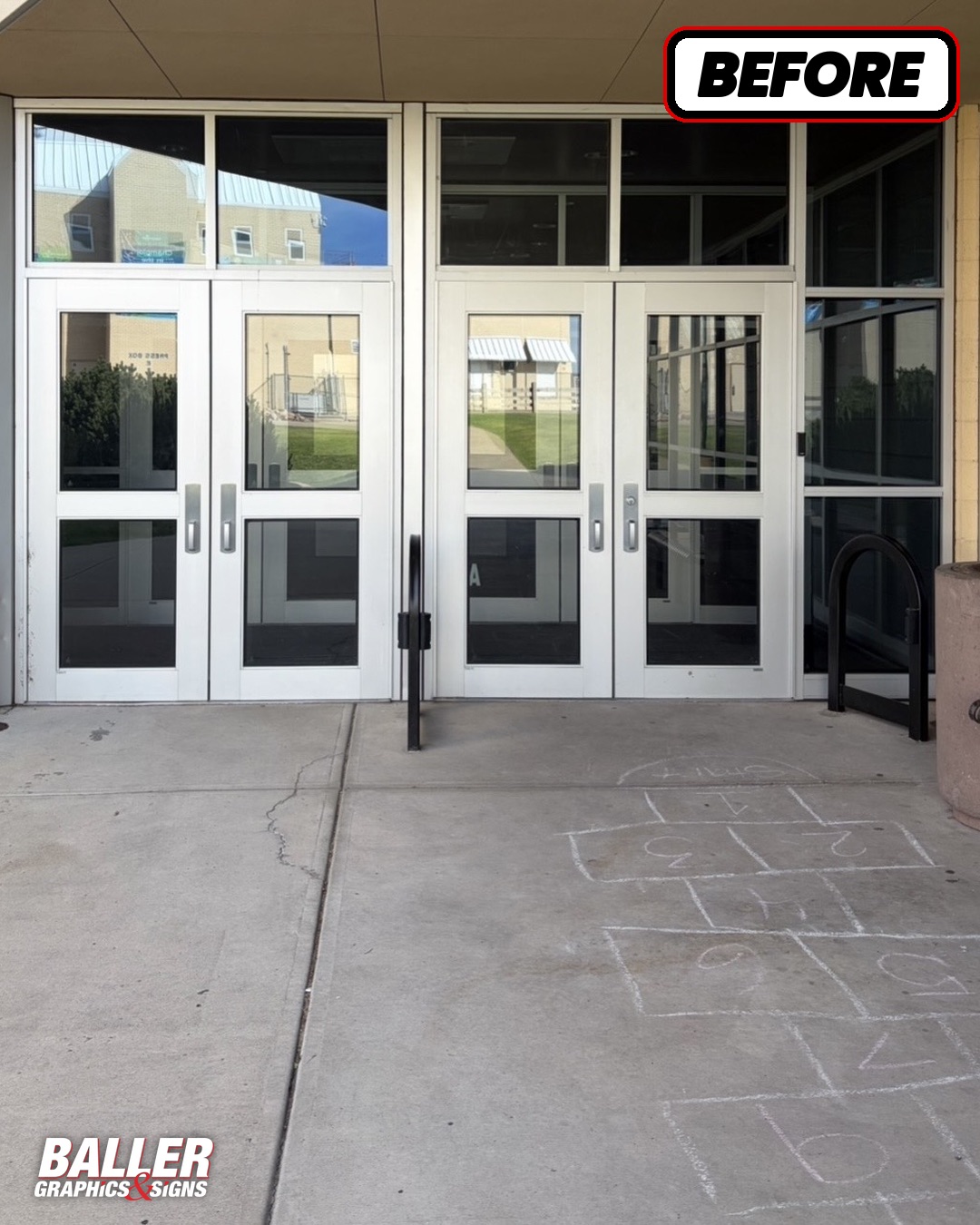 Plain glass athletic entrance doors before graphics at Douglas County High School