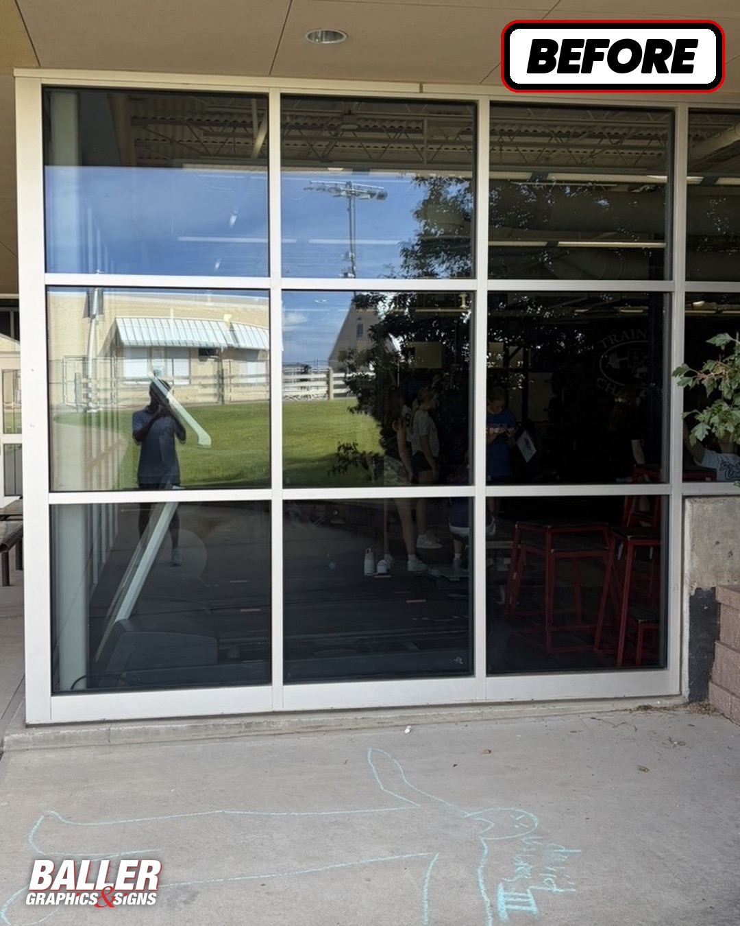 Blank reflective window wall before graphics at Douglas County High School
