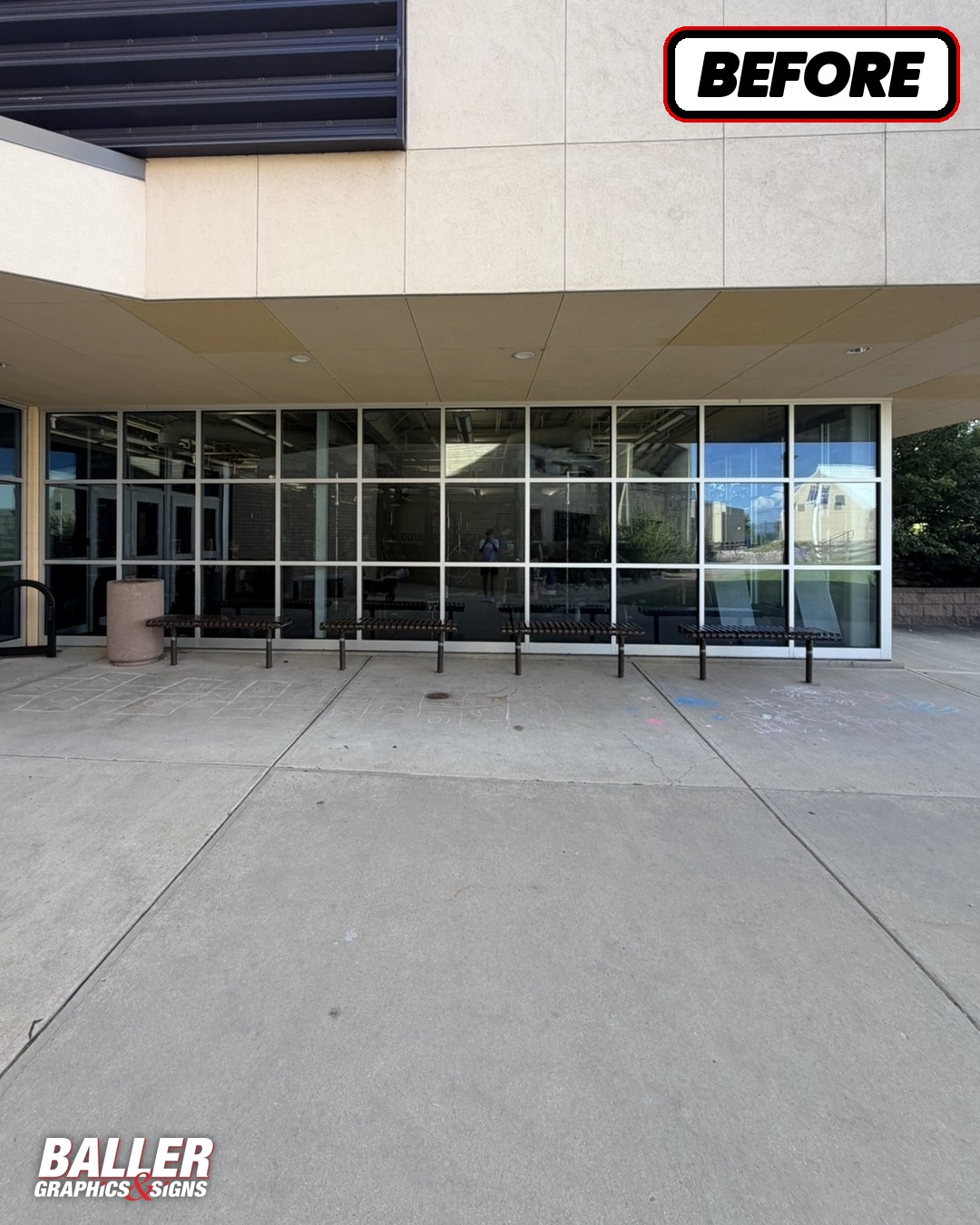 Blank glass storefront windows before graphics at Douglas County High School