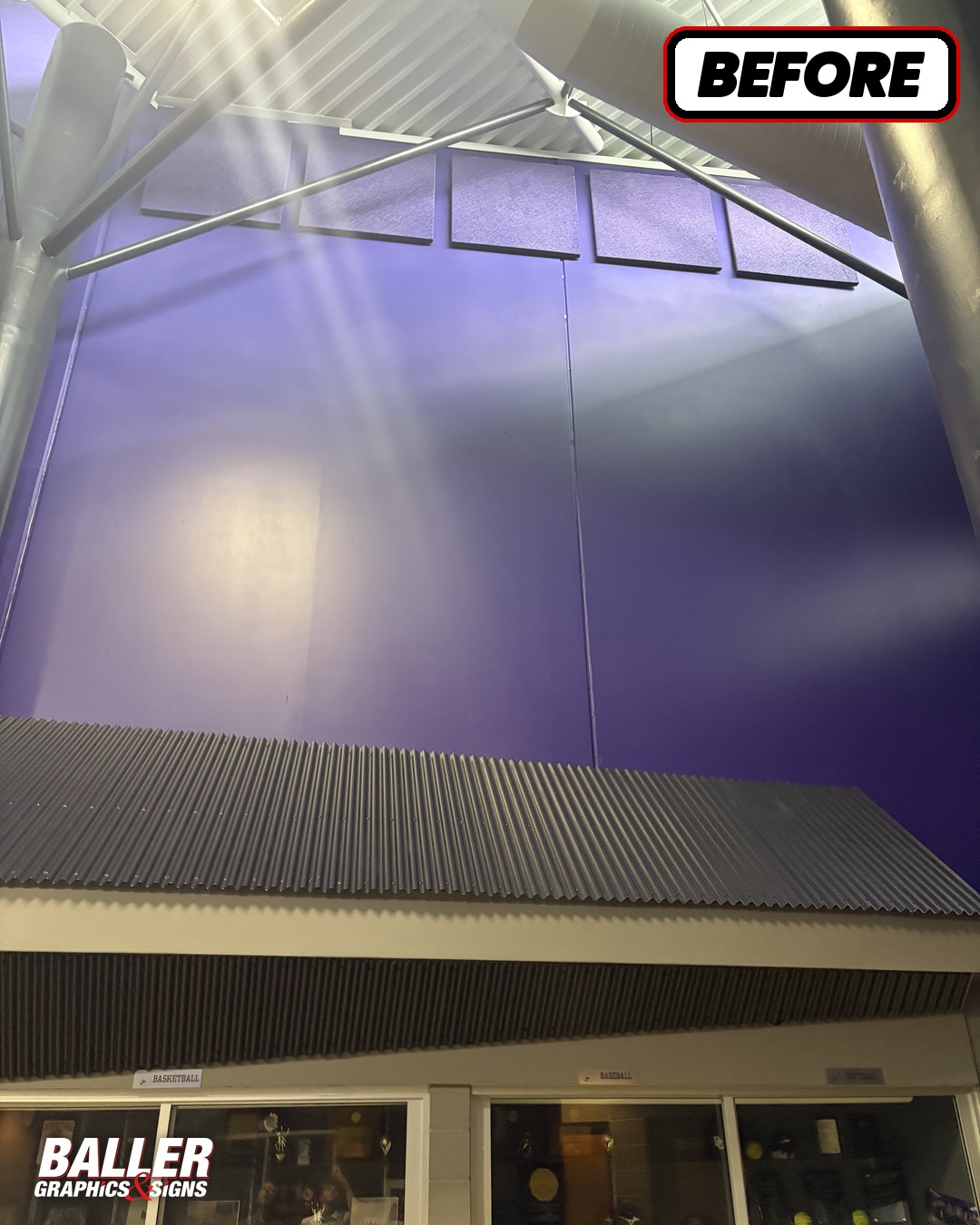 Blank purple gymnasium wall before graphics at Douglas County High School
